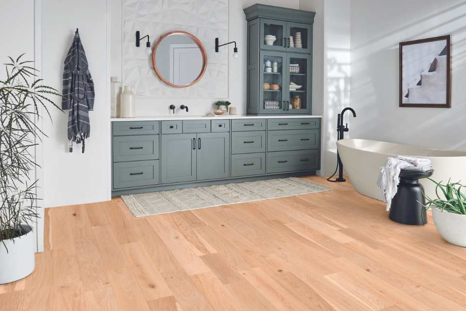 easy care natural white oak engineered wood in bathroom with blue cabinetry